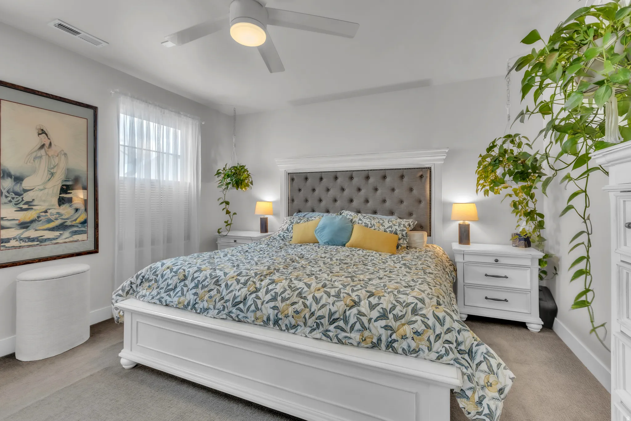 Bedroom featuring wood-finish flooring, a ceiling fan with integrated lighting, and a window with blinds and sheer curtains