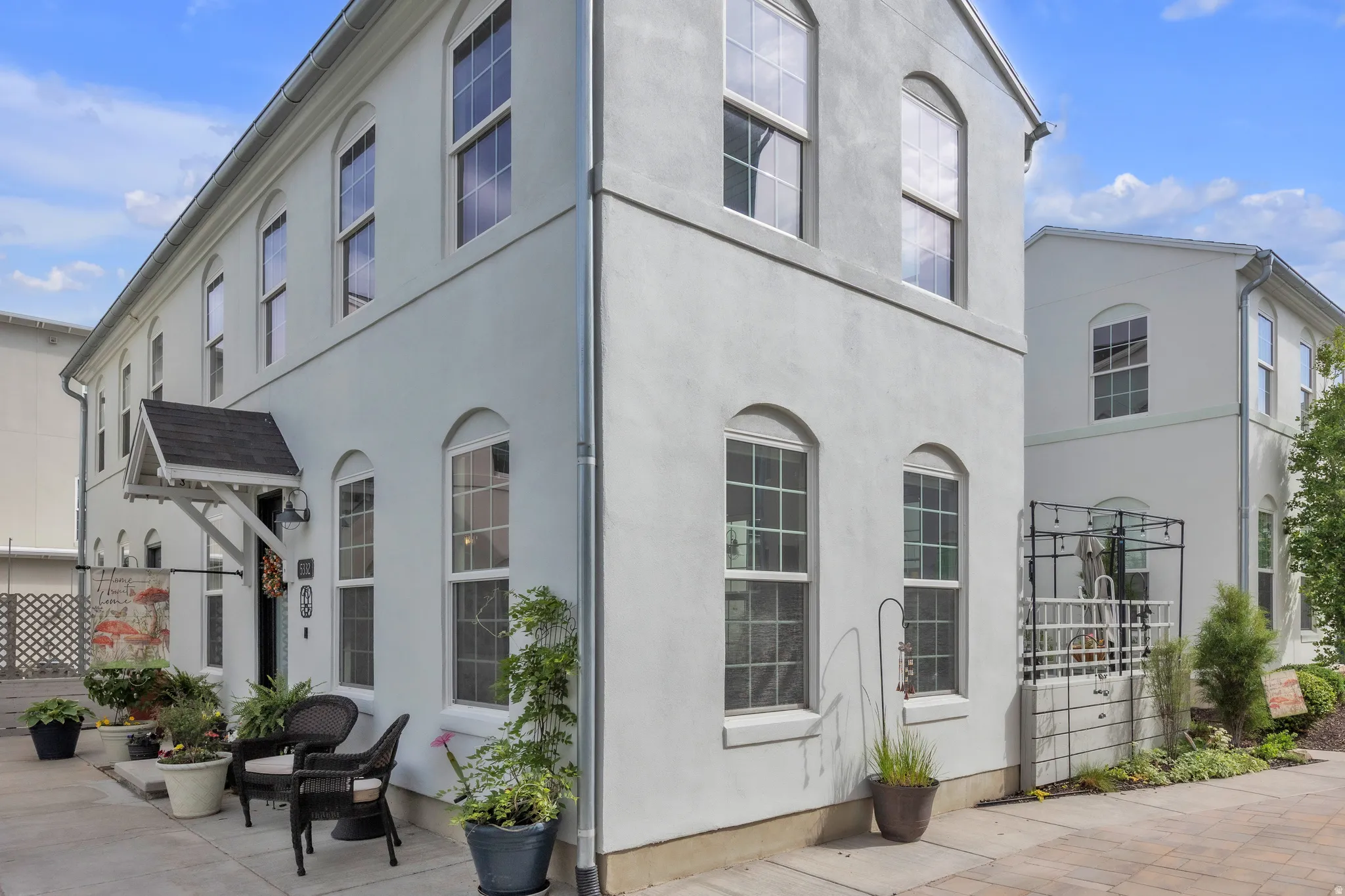 Stucco exterior featuring multiple arched windows with mullions