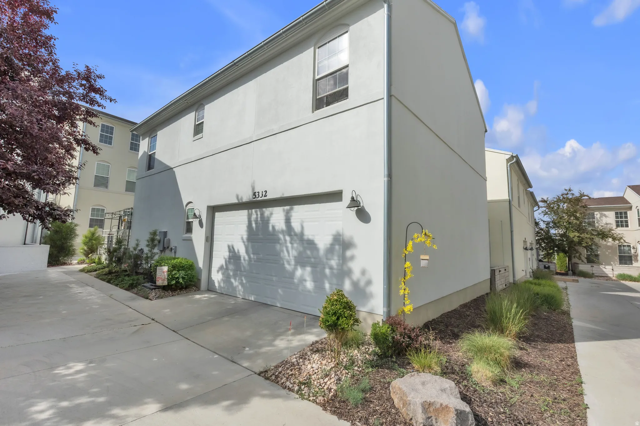 Exterior stucco finish with a two-story design and an integrated garage