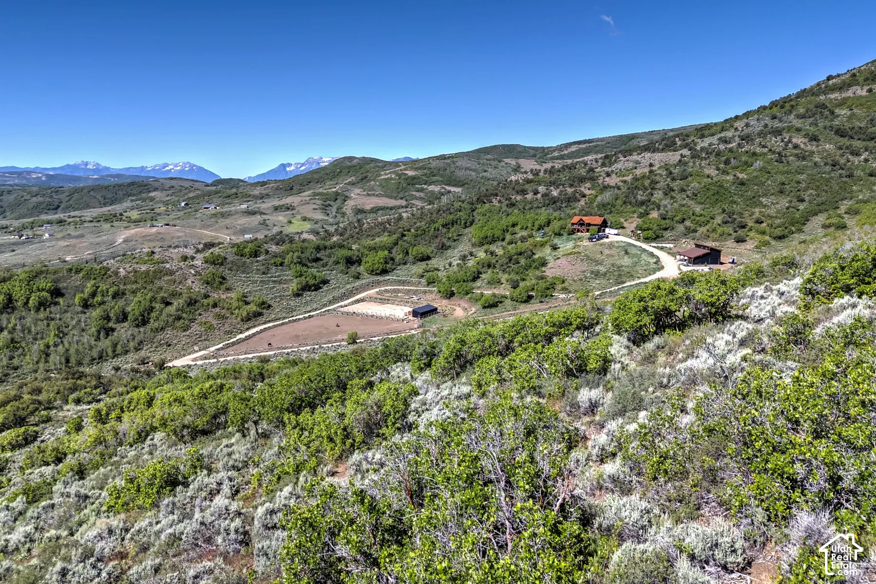 Expansive property showcasing a main residence, an additional structure, and a cleared land area