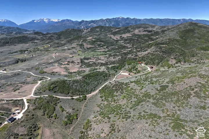 Expansive mountainous landscape with scattered buildings and winding paths