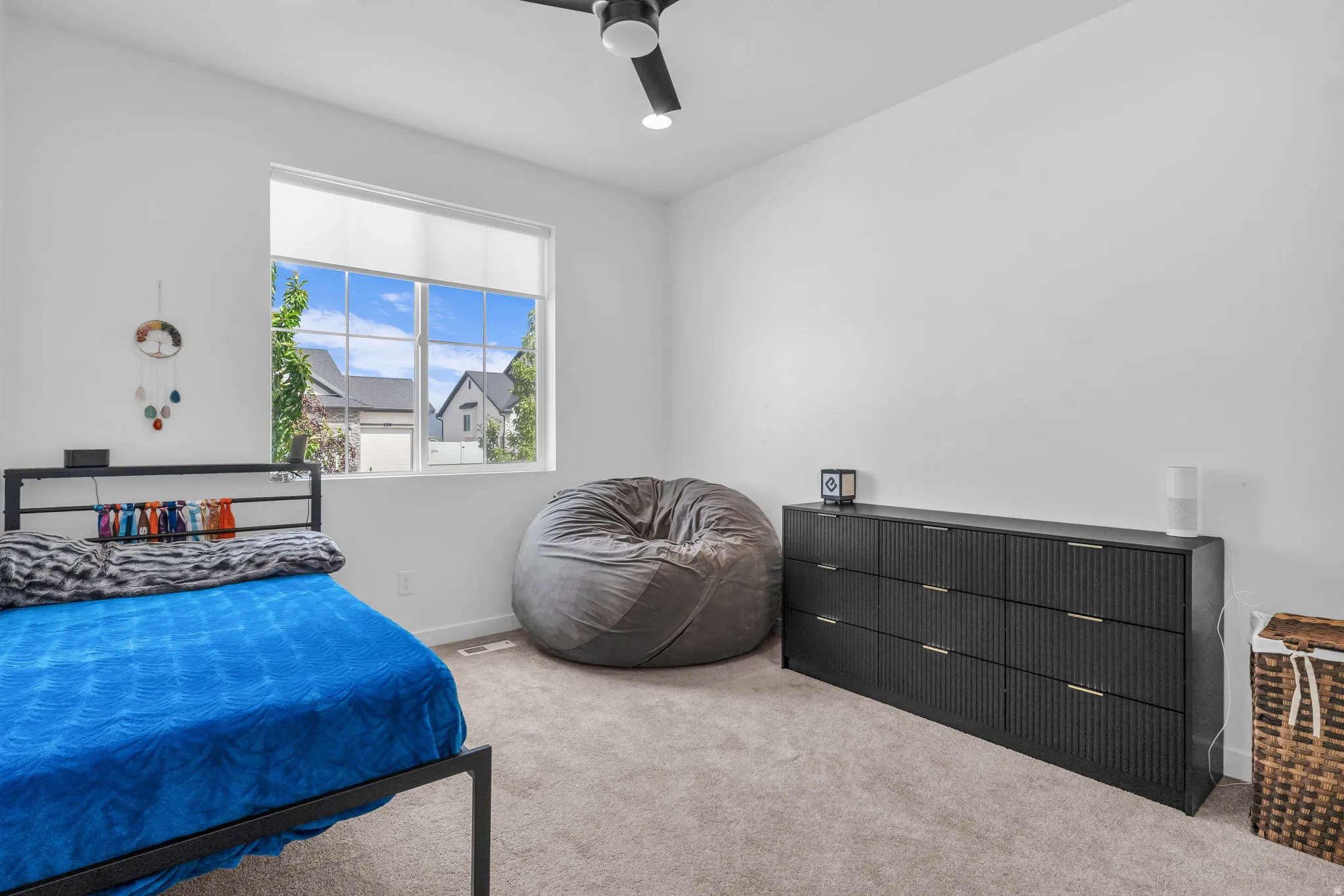 White walls with a single large window featuring horizontal blinds