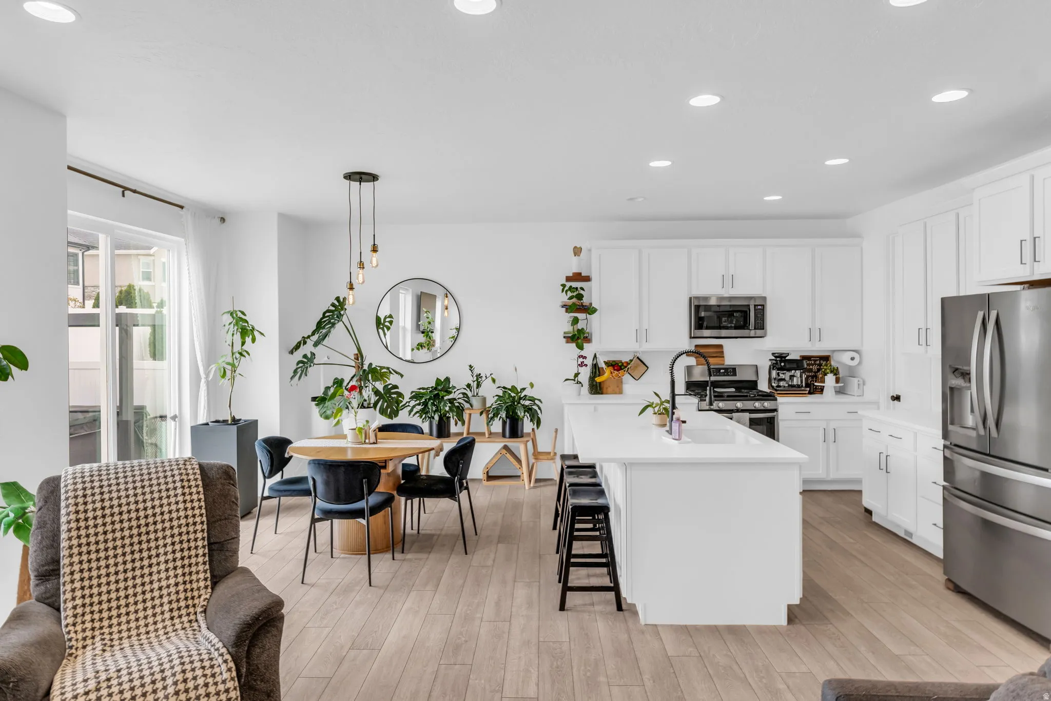 Open-concept living space with light wood-finish flooring