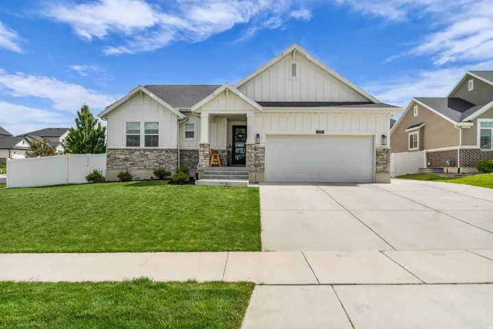 Modern Craftsman-style exterior featuring board and batten siding and stone veneer accents