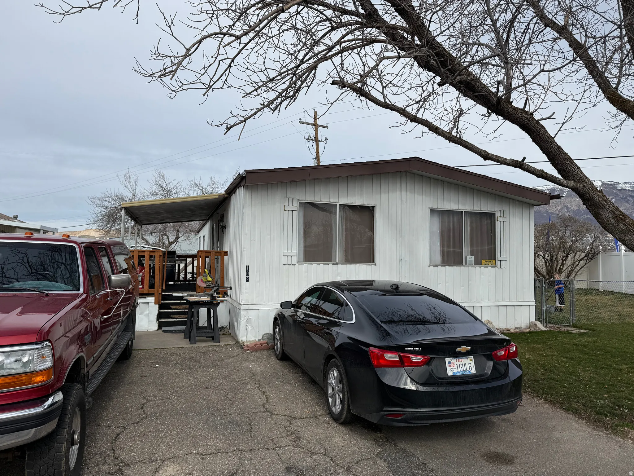 White-sided exterior featuring multiple windows and a brown trim roofline