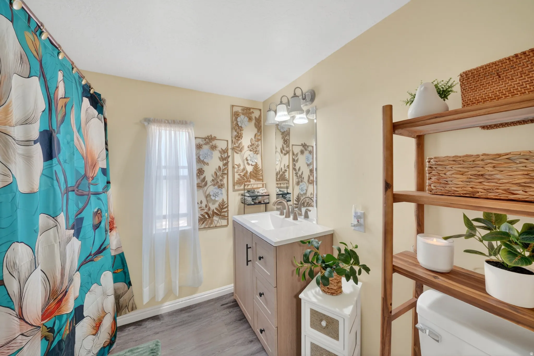 Bathroom featuring a single vanity with a white countertop and dark hardware