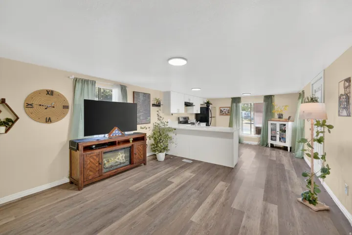 Expansive living area featuring wood-finish flooring and light-toned walls