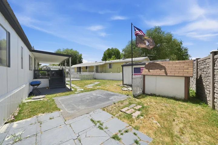 Covered patio area with exterior access and an adjacent storage shed