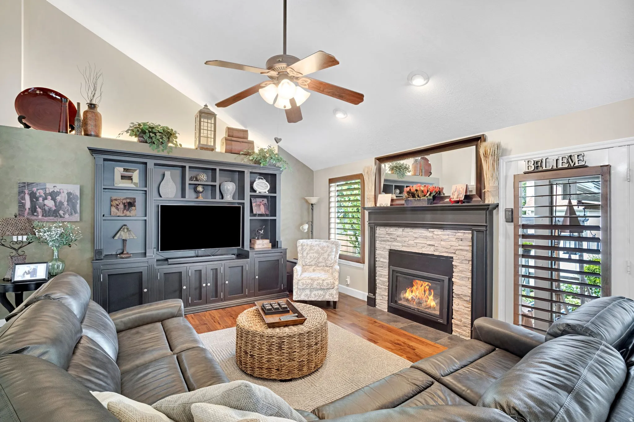 Vaulted ceiling great room, heatilator fireplace with updated stone and a dark wood mantel, built-in entertainment center, ceiling fan, and plantation shutters.  Cove lighting for beautiful accent.