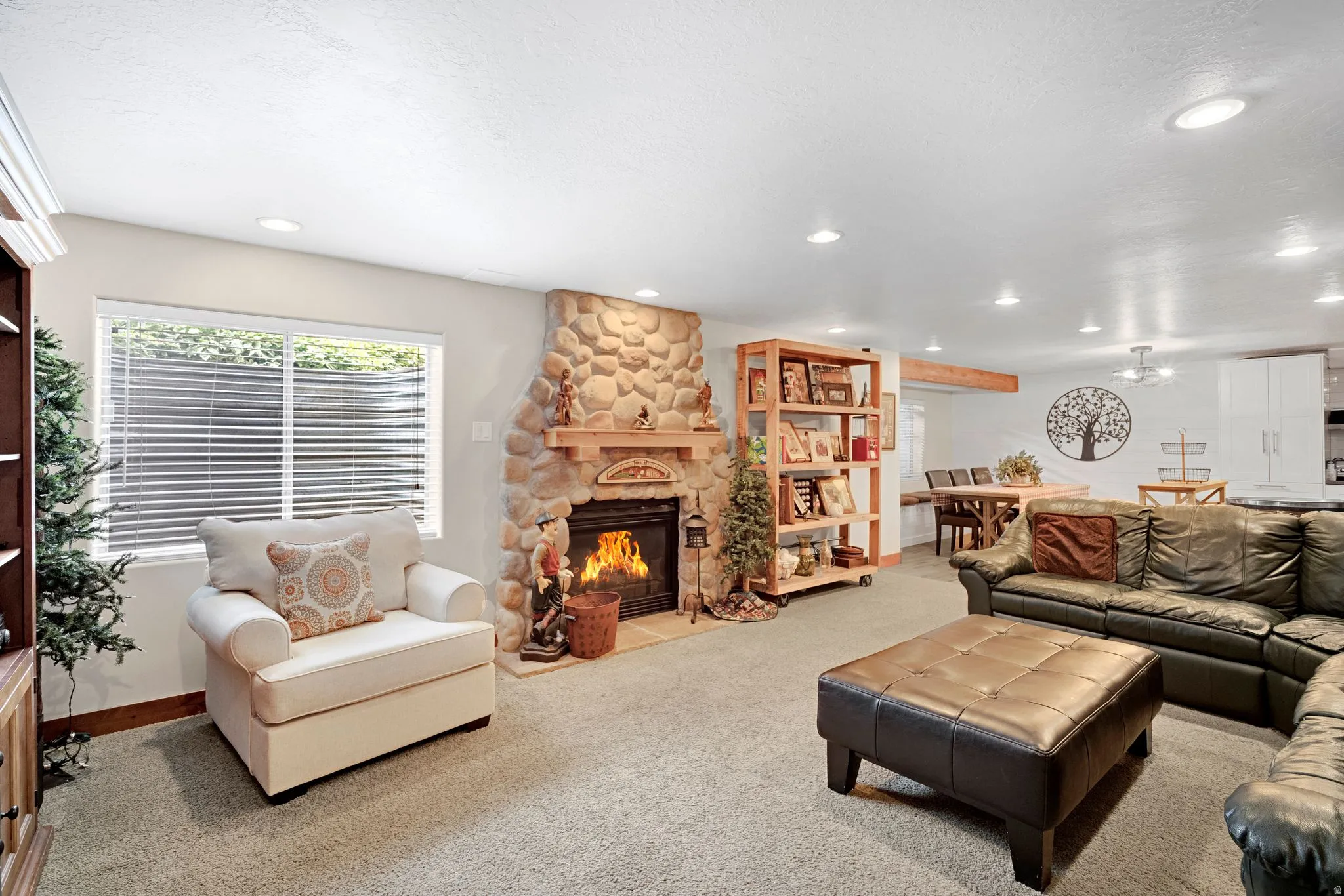 Spacious entertainment area featuring a stone-faced heatilator fireplace, beautiful second kitchen (only a few years old).