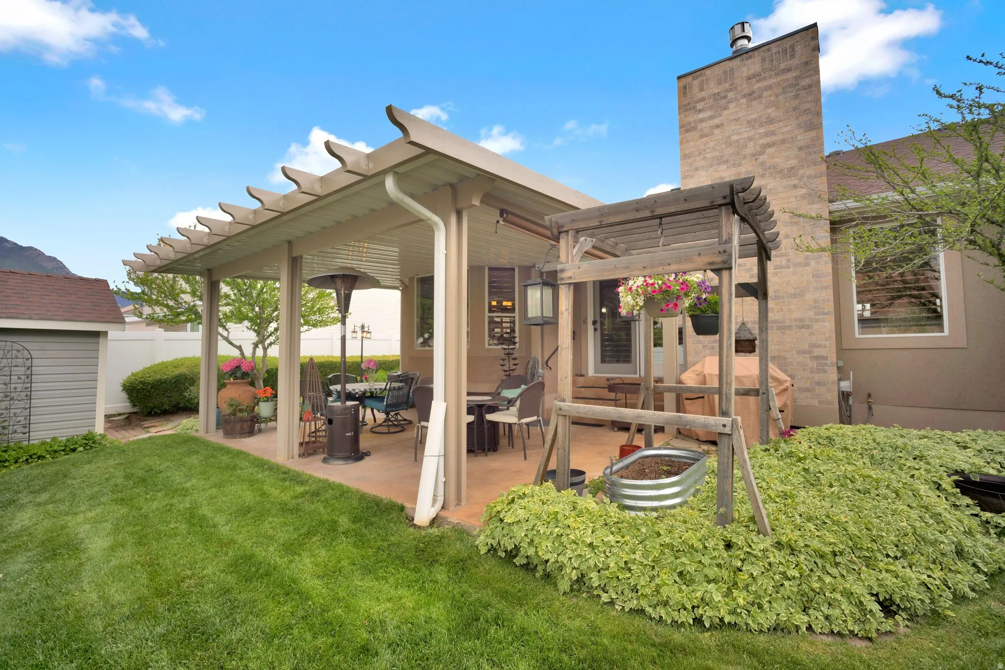 Covered patio with stained concrete.  Beautiful landscaping (meticulously maintained).