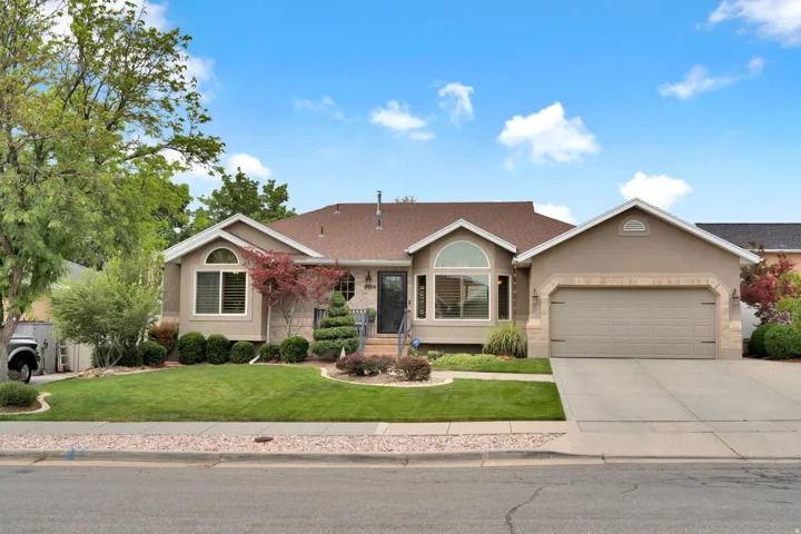 Ranch-style residence featuring an updated stucco exterior and an attached two-car garage with excellent curb appeal.