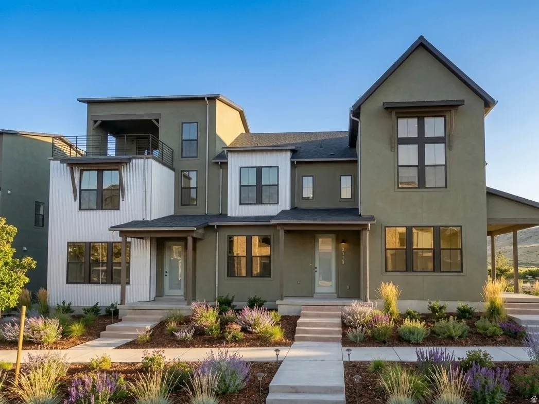 Modern multi-level townhomes featuring complementary green and white stucco exteriors