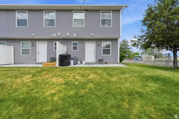 Expansive green lawn extending from a concrete patio