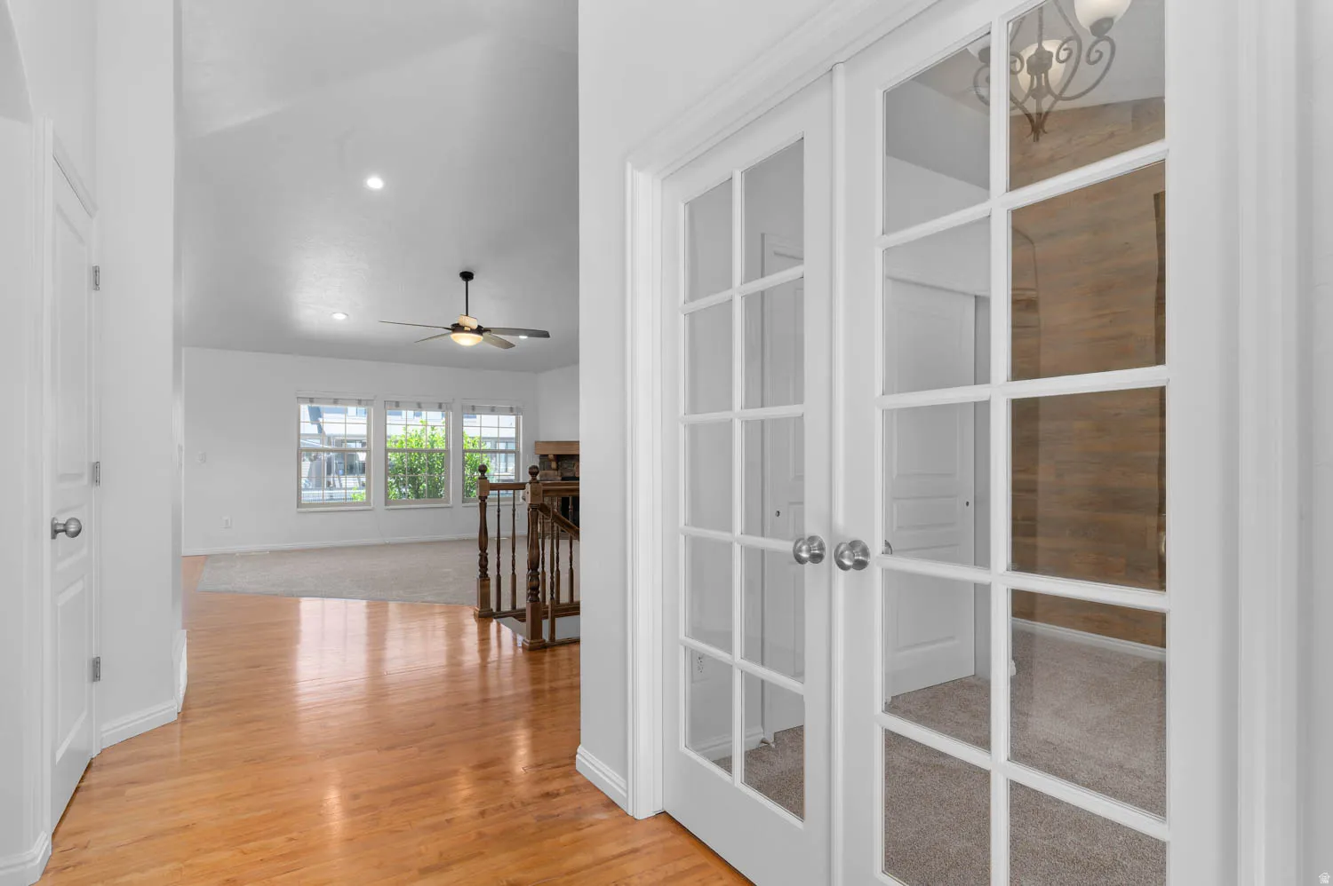 White French doors open to a carpeted room