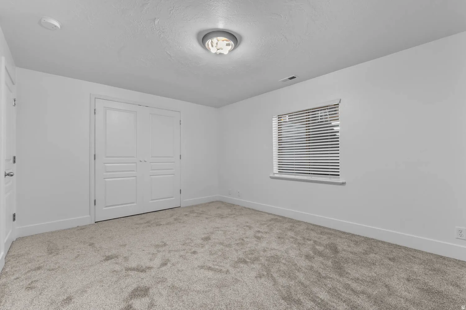 Neutral-toned carpeting and white walls