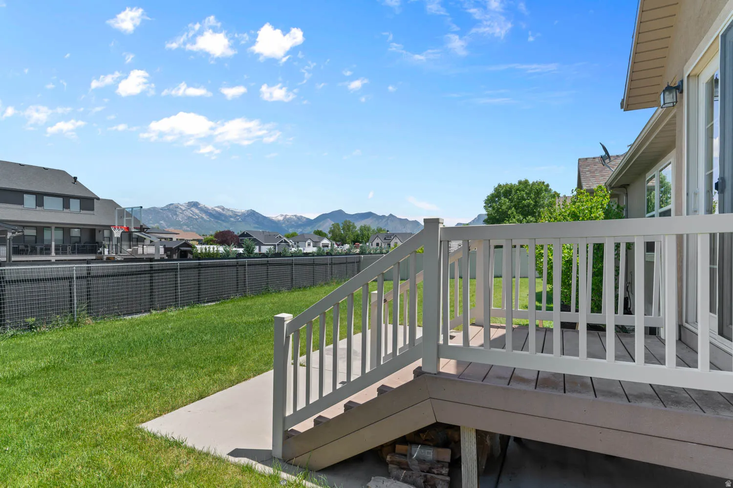 Spacious backyard with a large deck and mountain backdrop