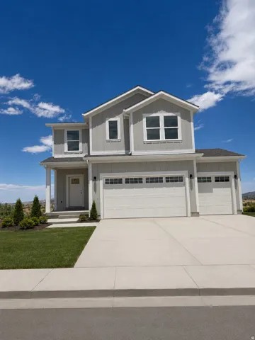 Modern two-story residence featuring light gray siding and white trim accents