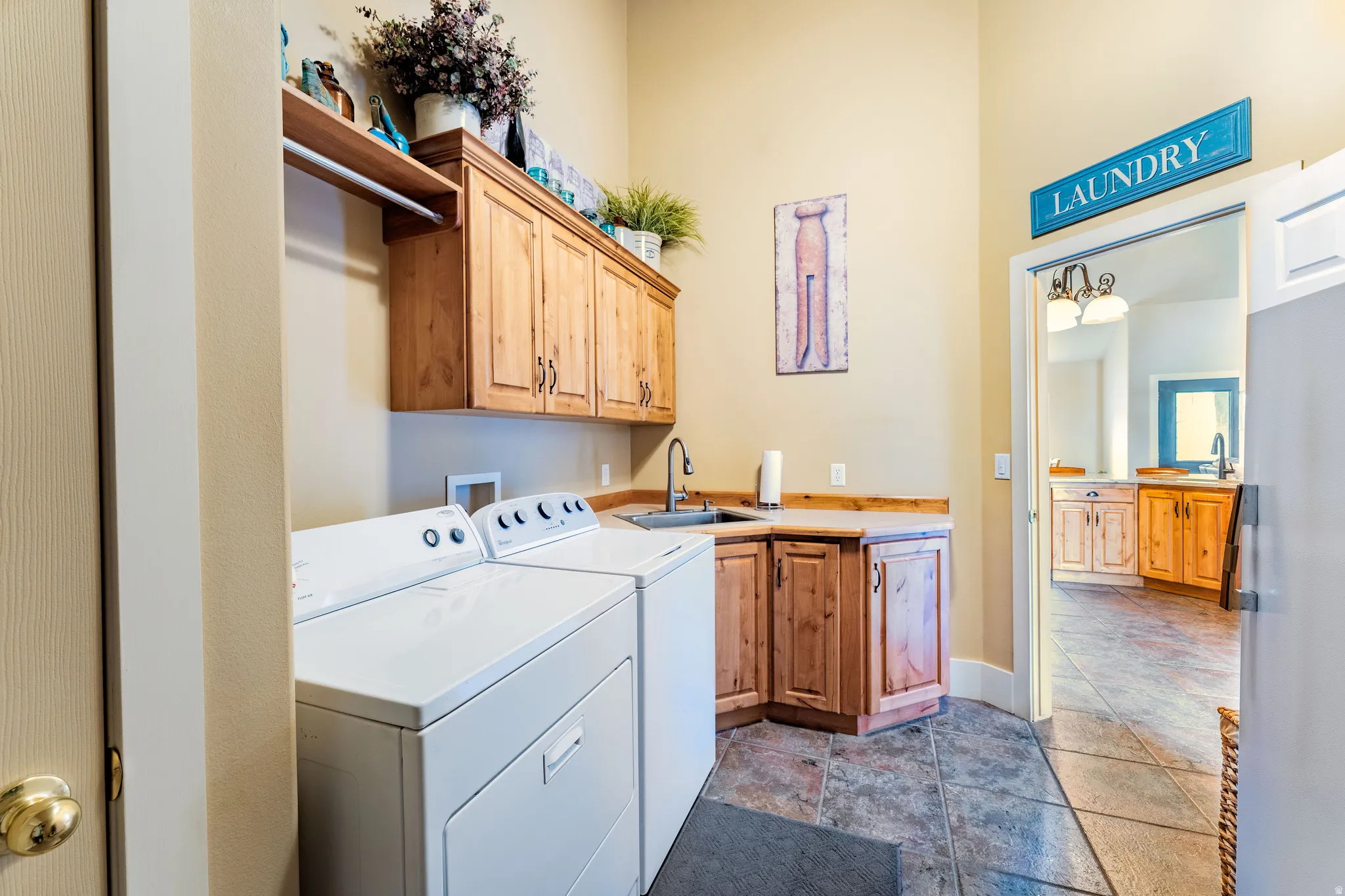 Laundry area featuring alder cabinetry, a utility sink, and ample countertop space
