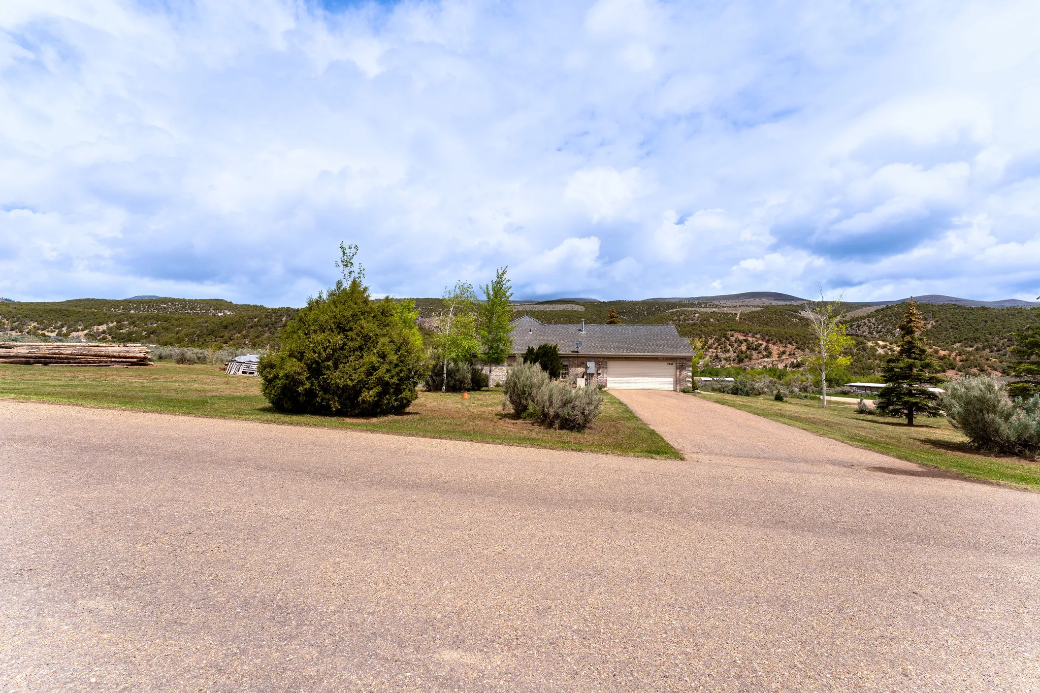 Ranch-style exterior with a front-facing garage, asphalt driveway, and a shingle roof