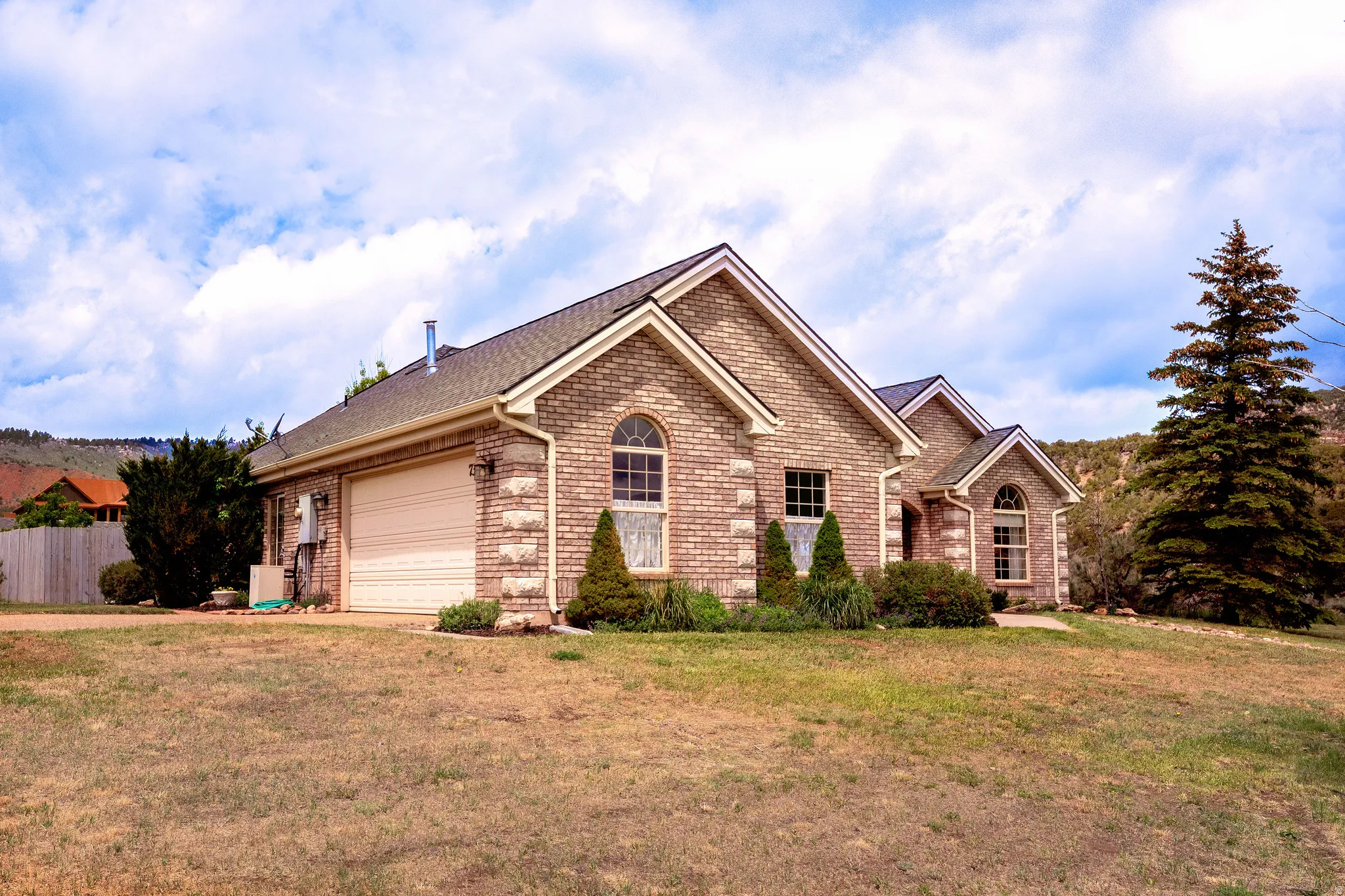Brick exterior featuring stone accents and arched windows