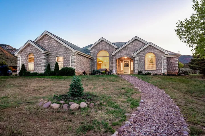Brick exterior residence featuring arched windows and gabled rooflines