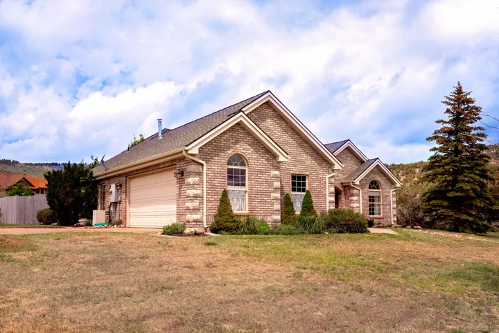 Brick exterior featuring stone accents and arched windows