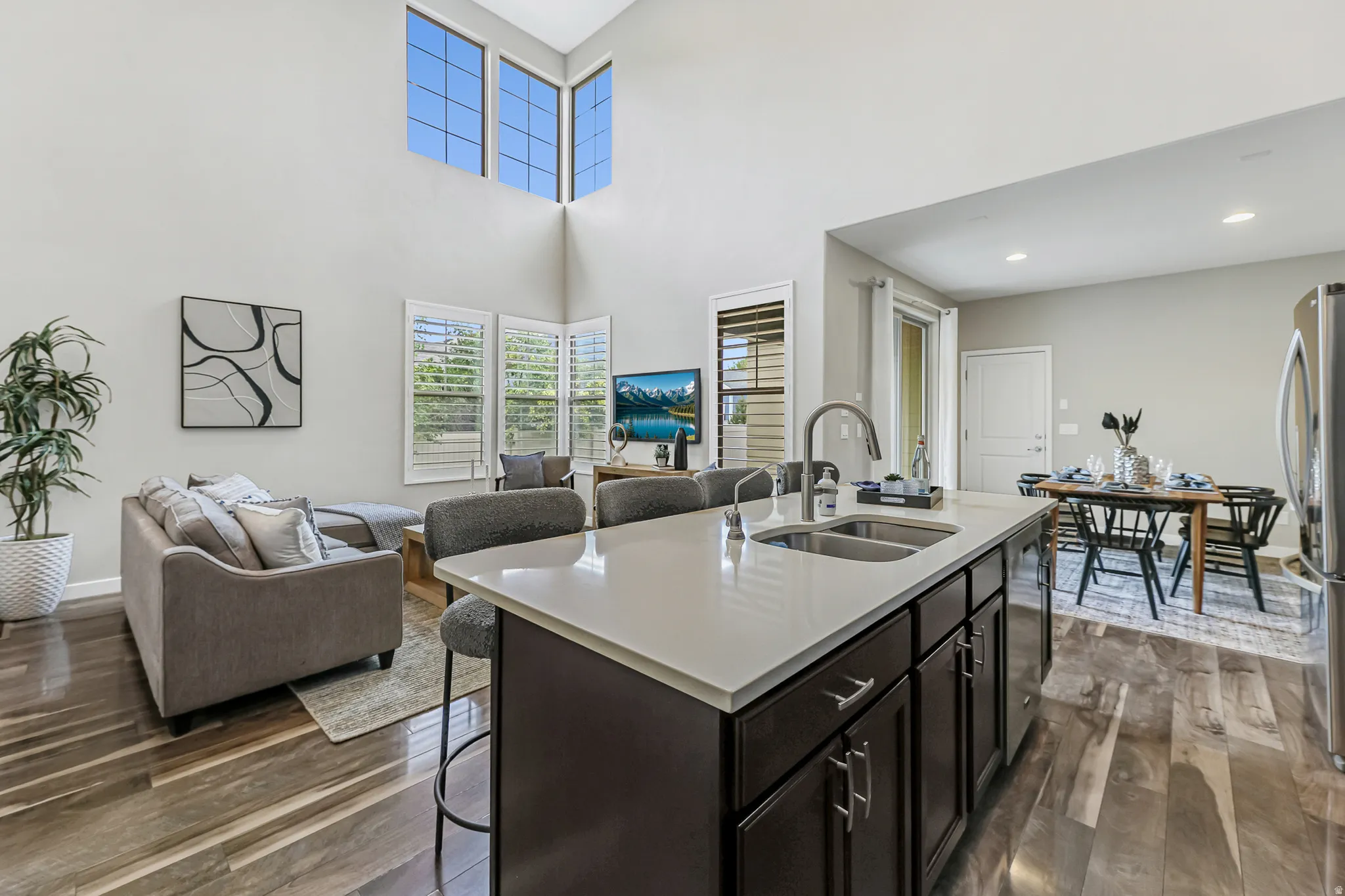 Kitchen island featuring a double-basin stainless steel sink and a single-handle faucet