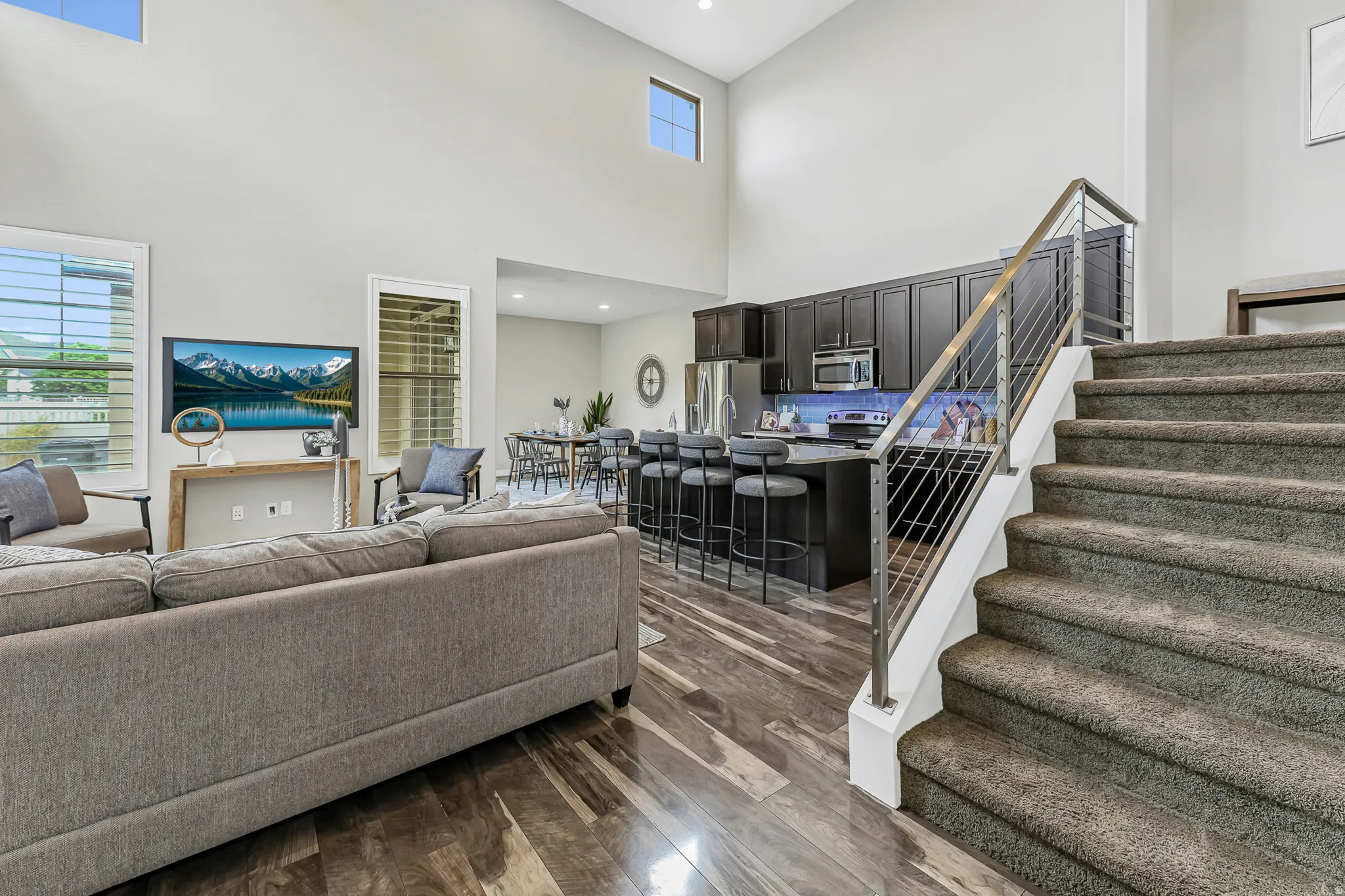 High ceilings and wood-finish flooring define this inviting living area