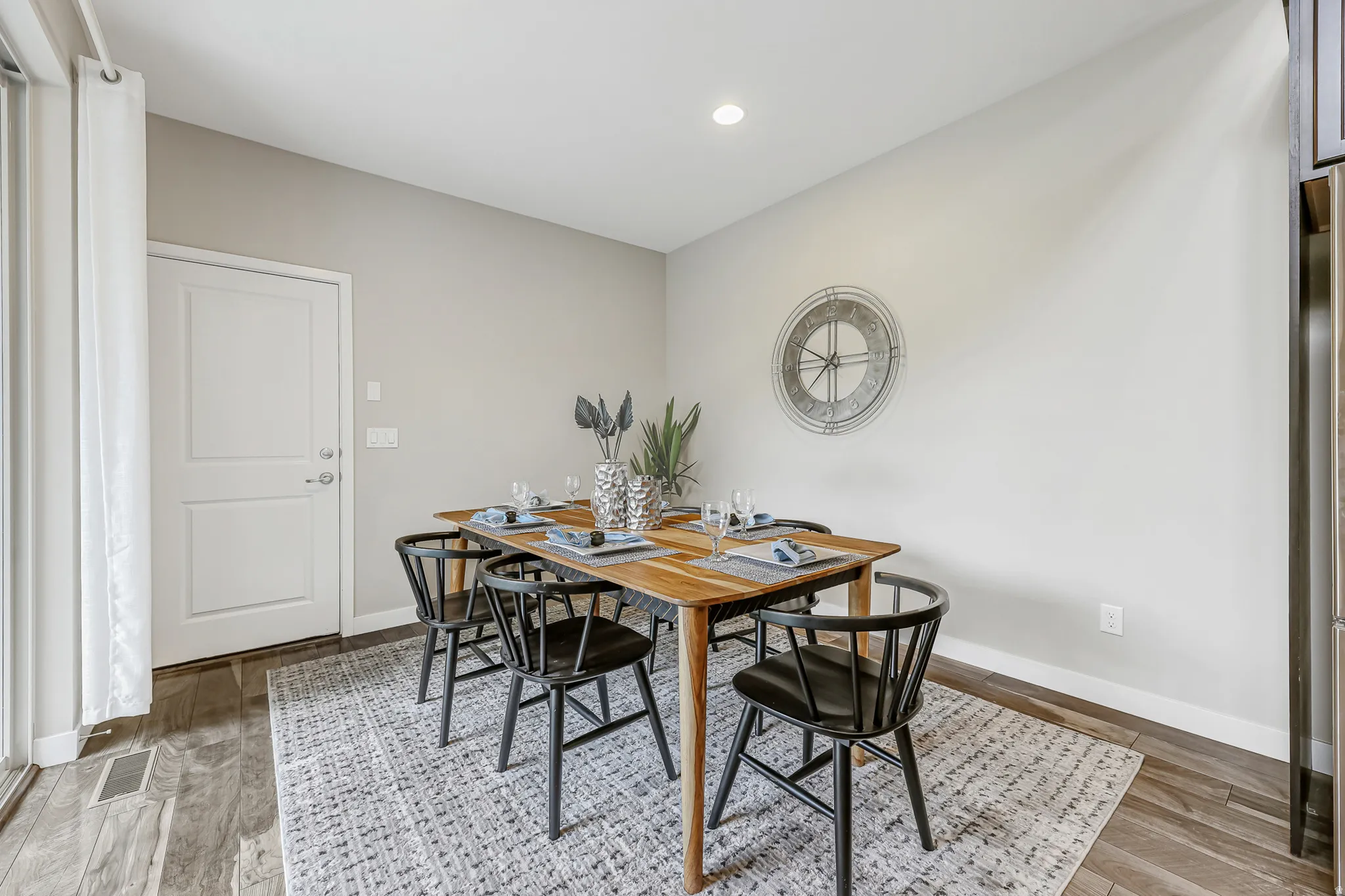 Dining area featuring wood-finish flooring, light neutral wall paint, and a built-in recessed ceiling light