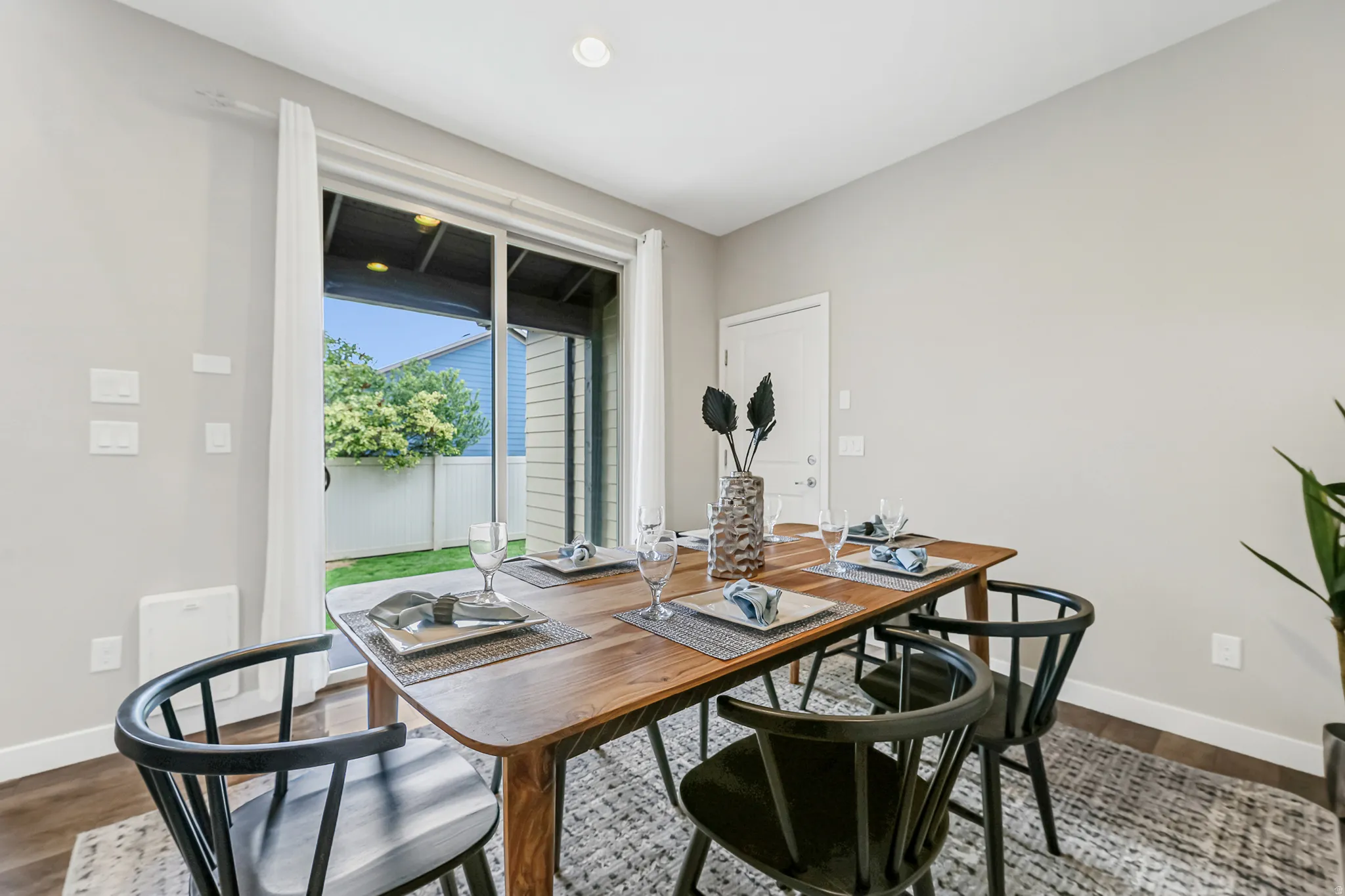 Dining area with wood-finish flooring and light gray walls