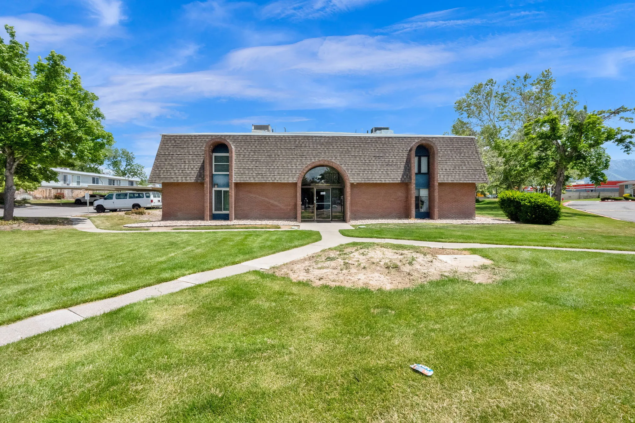 Brick exterior building with an arched entryway and matching arched windows