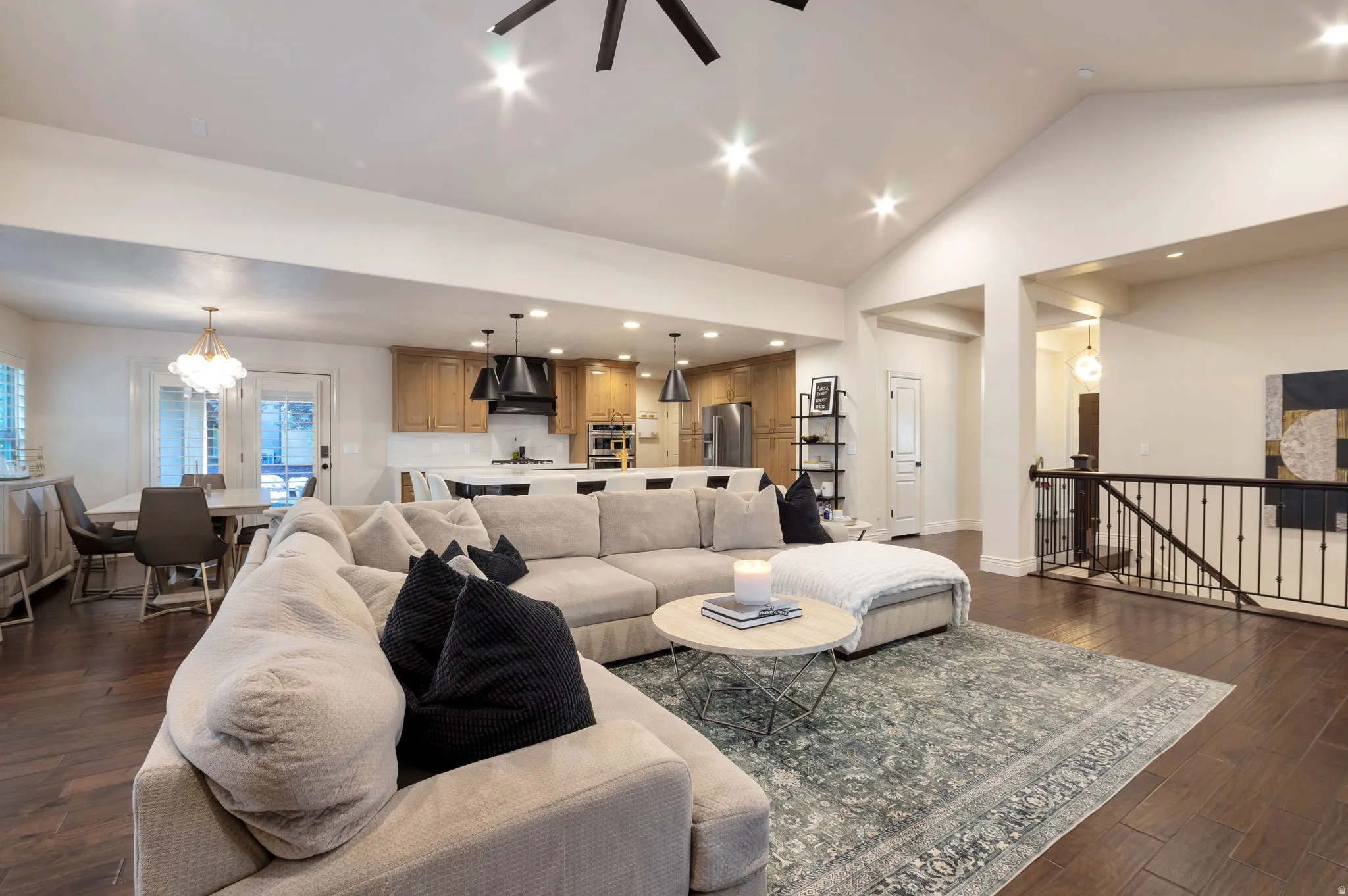 Open-concept living space with hardwood flooring and vaulted ceilings