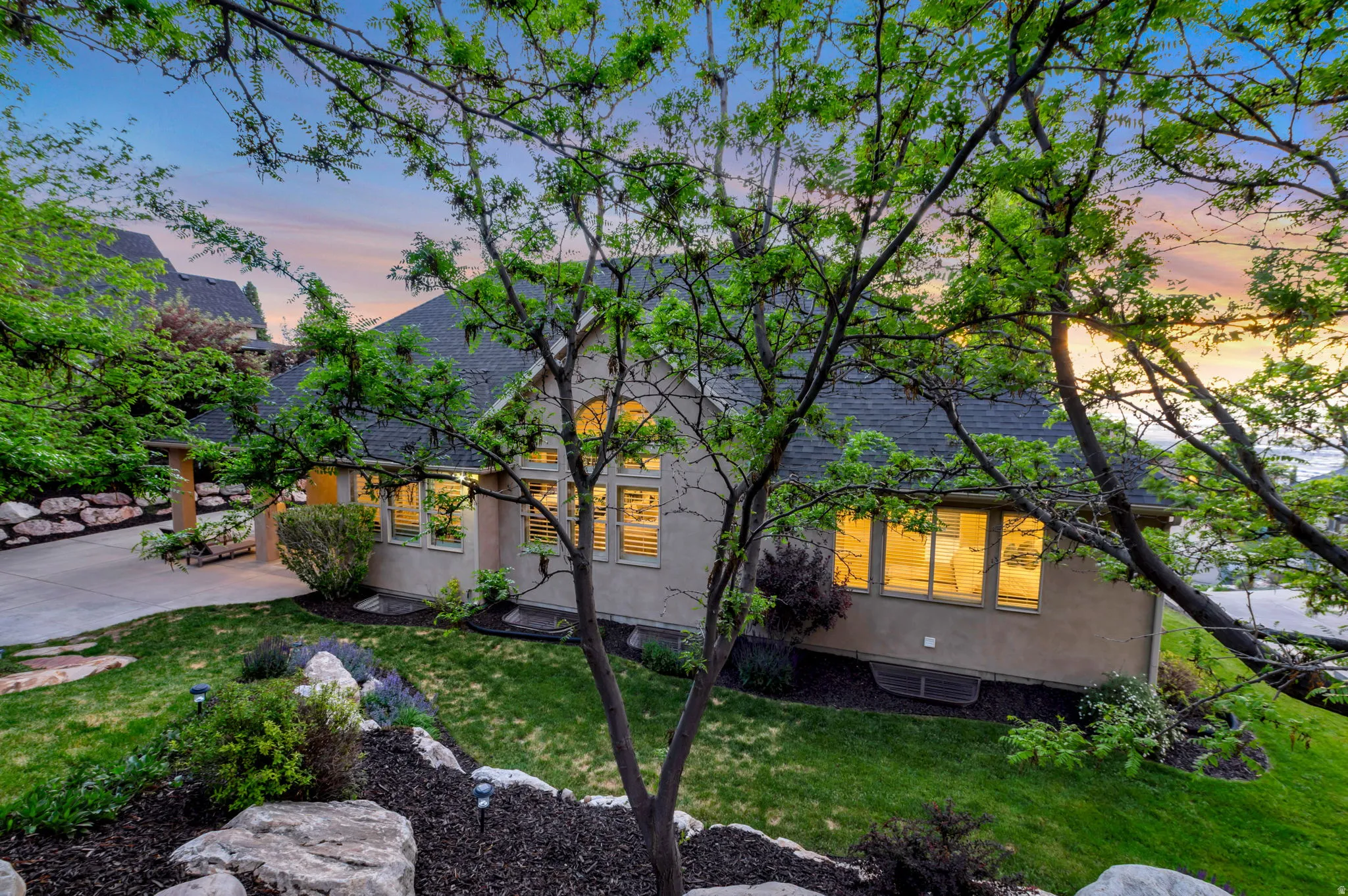 Stucco exterior with multiple windows featuring plantation shutters