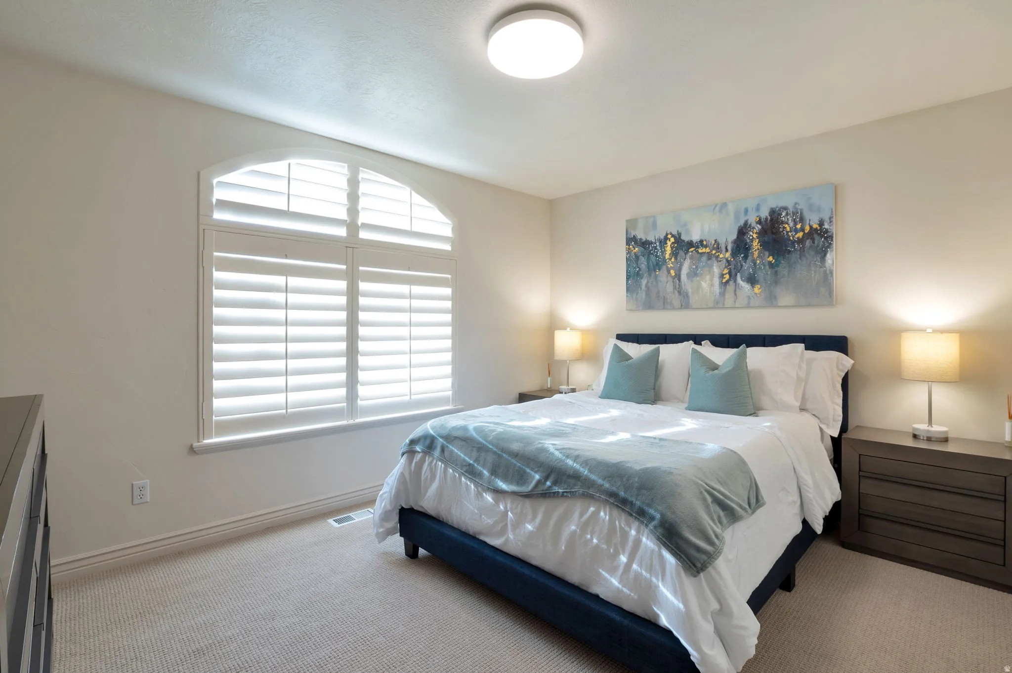 Arched window with plantation shutters