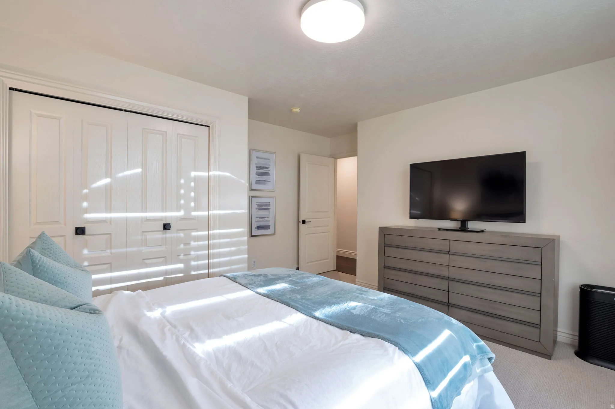 Bedroom featuring light-toned walls and carpet flooring