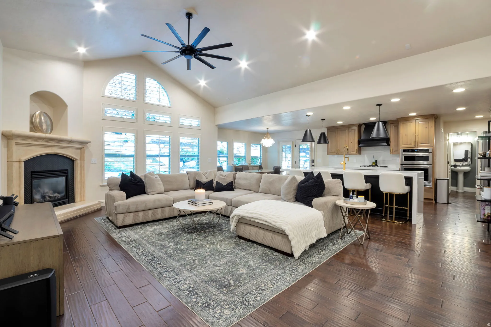 Expansive living area with vaulted ceilings and recessed lighting