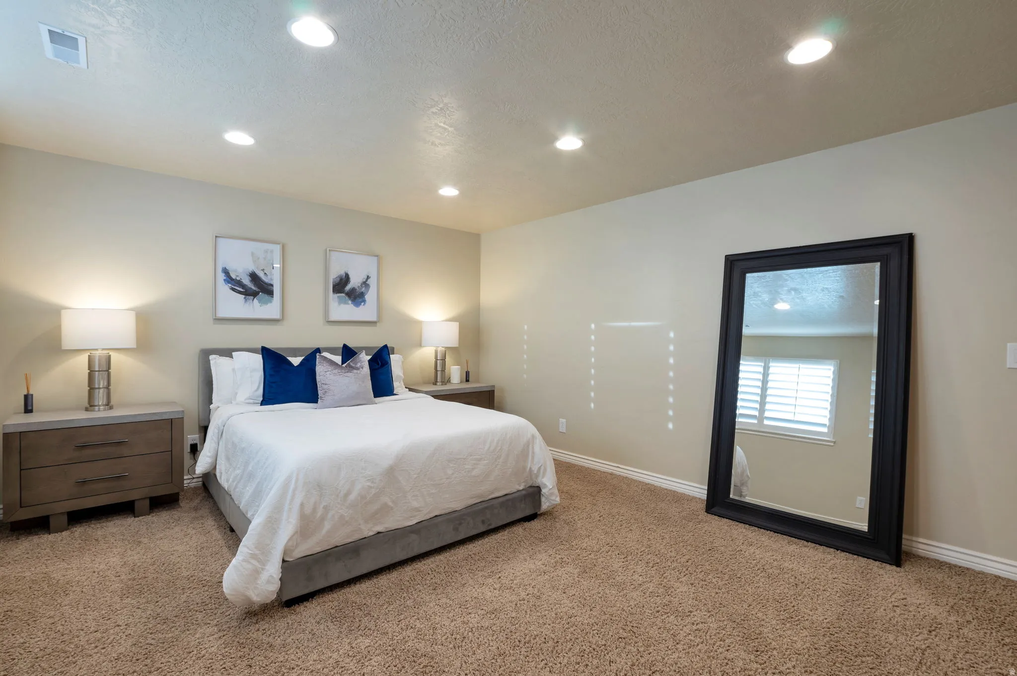 Neutral-toned walls complement plush carpeting