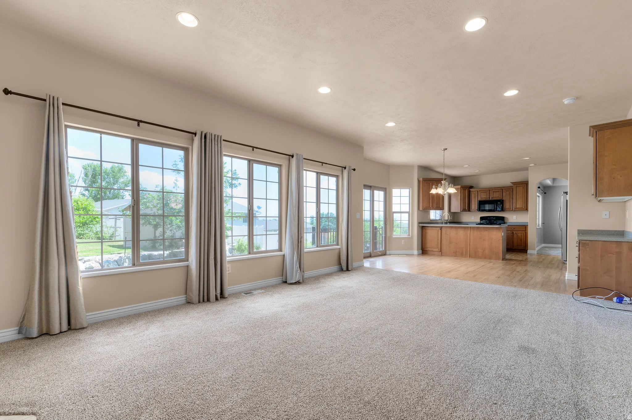 Spacious interior with neutral carpeting and recessed lighting