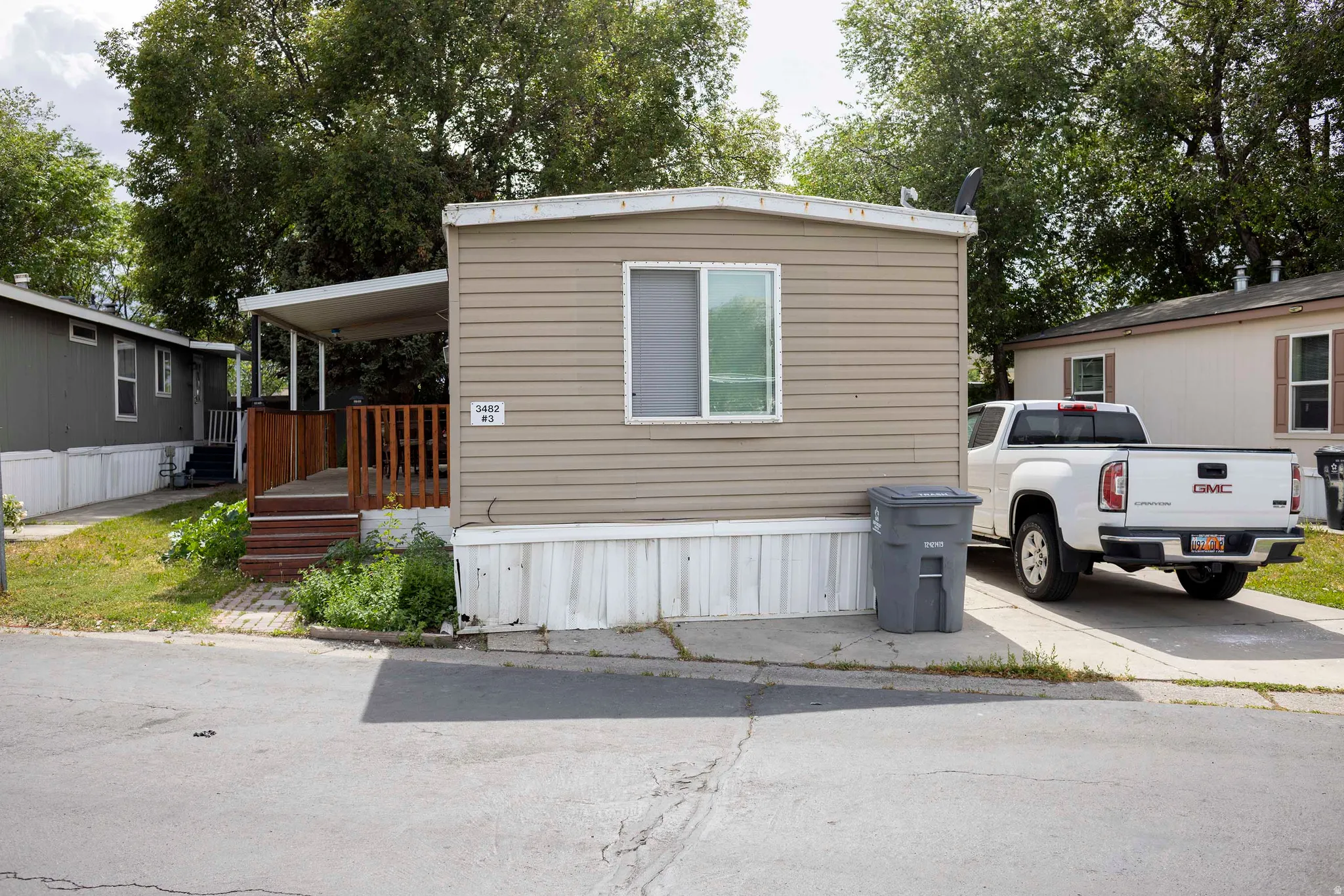 Tan horizontal siding exterior with white trim