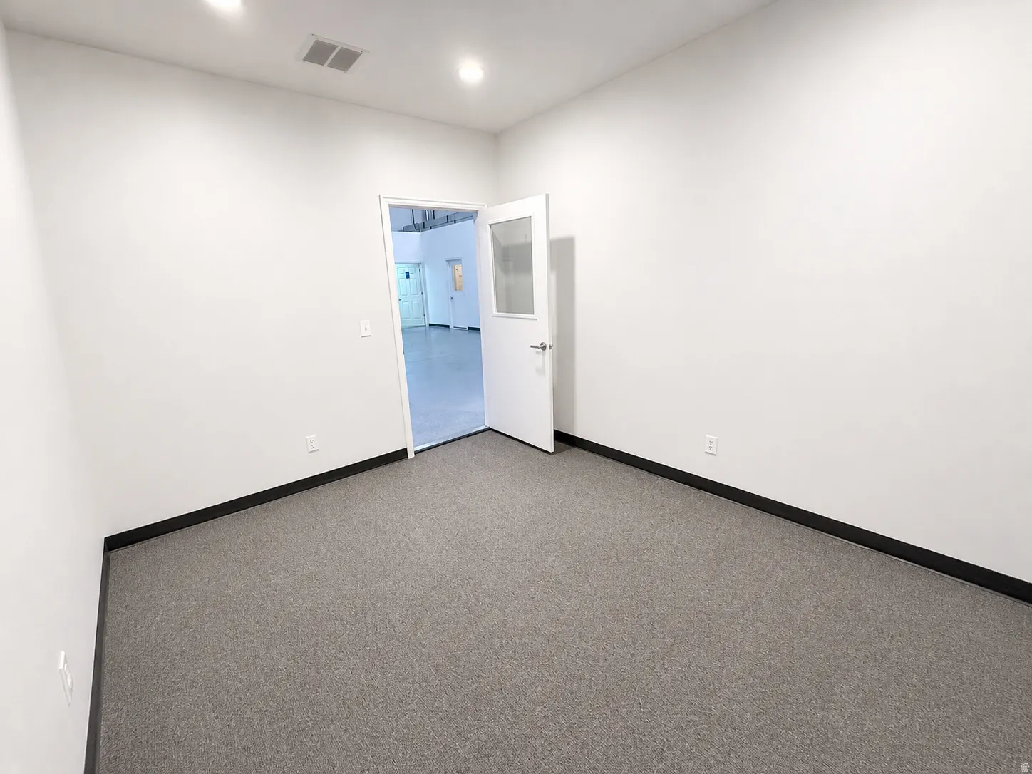 Room with gray carpet flooring and white walls