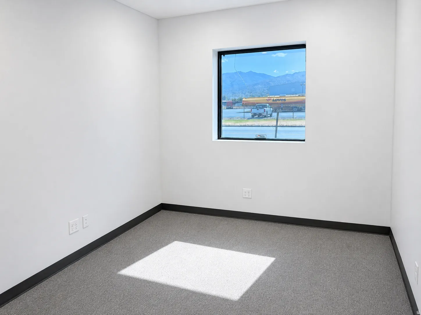 Bright interior room with a single window providing natural light