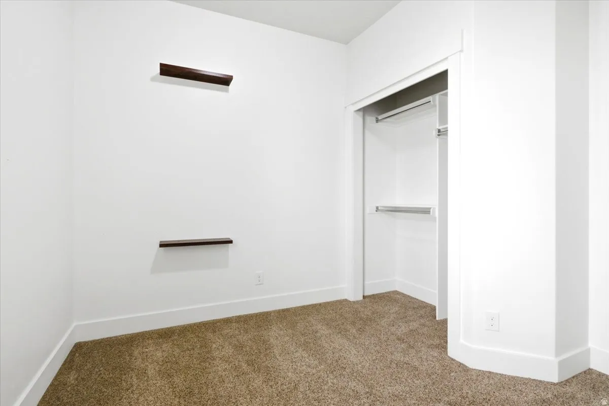 Room featuring light tan carpet and white walls