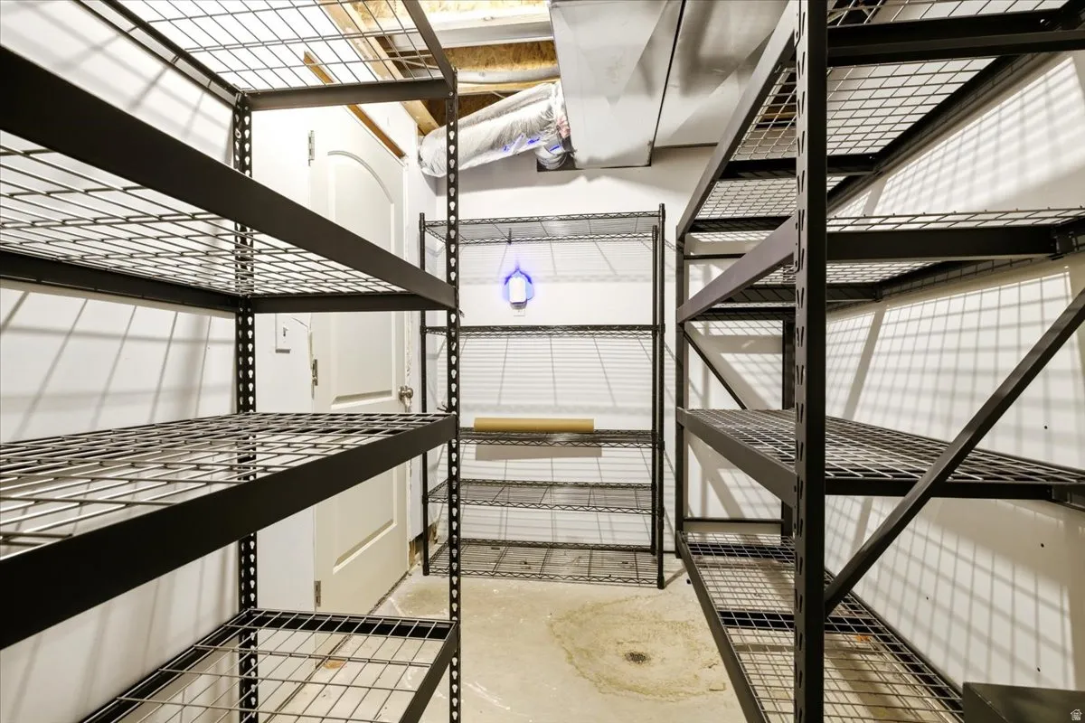 Utility room featuring multiple industrial-style metal shelving units
