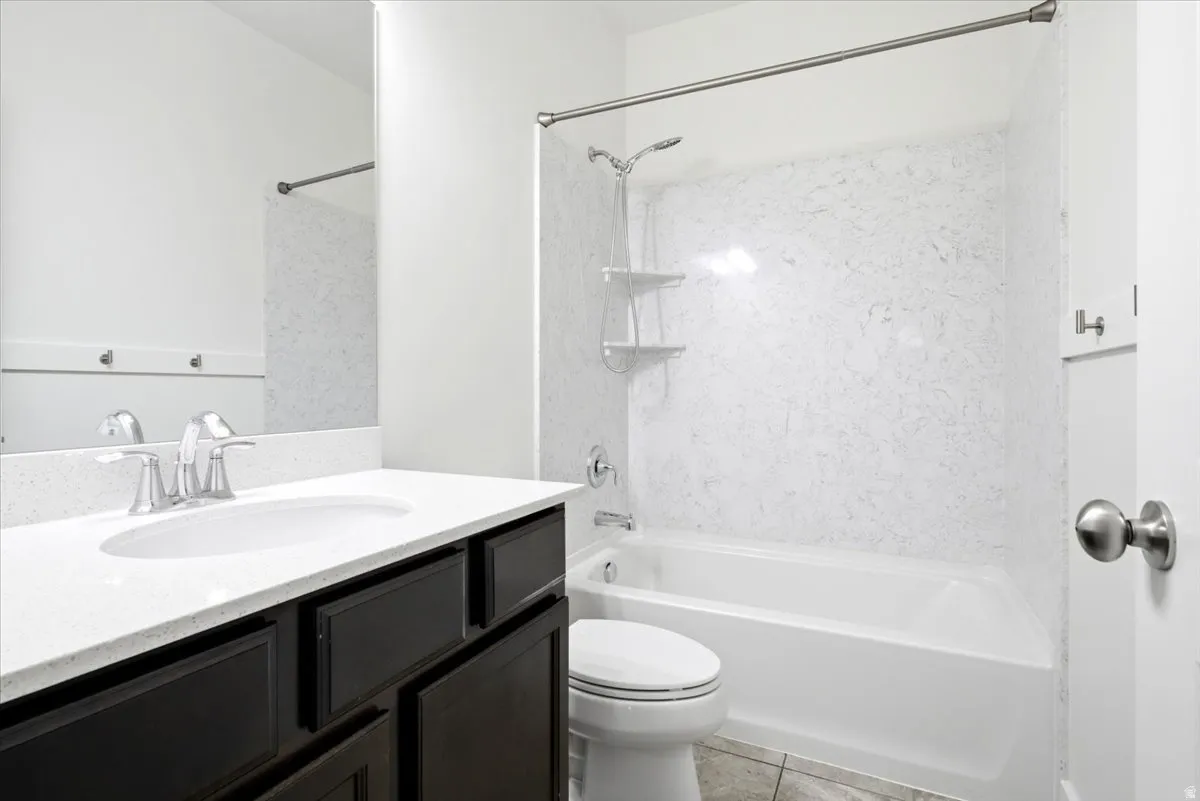 Bathroom featuring a dark wood-finish vanity with a white countertop and integrated sink