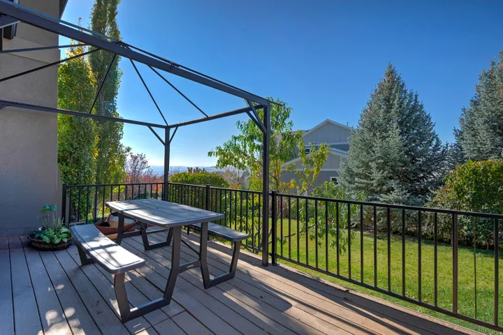 Expansive outdoor deck with composite decking and a black metal gazebo frame