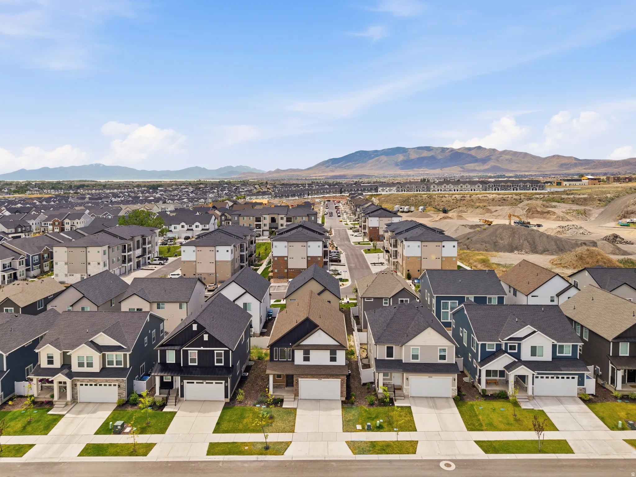 Residential development featuring a variety of architectural styles, paved roadways, and landscaped front yards