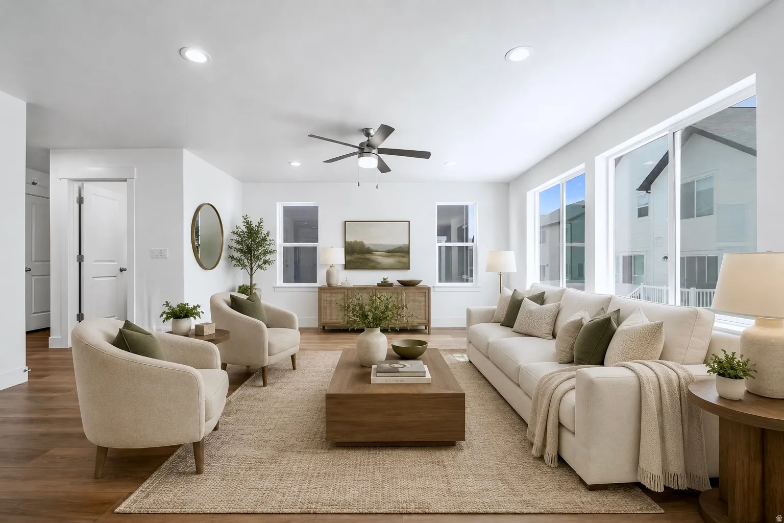 Bright living area featuring wood-finish flooring, recessed lighting, and a ceiling fan