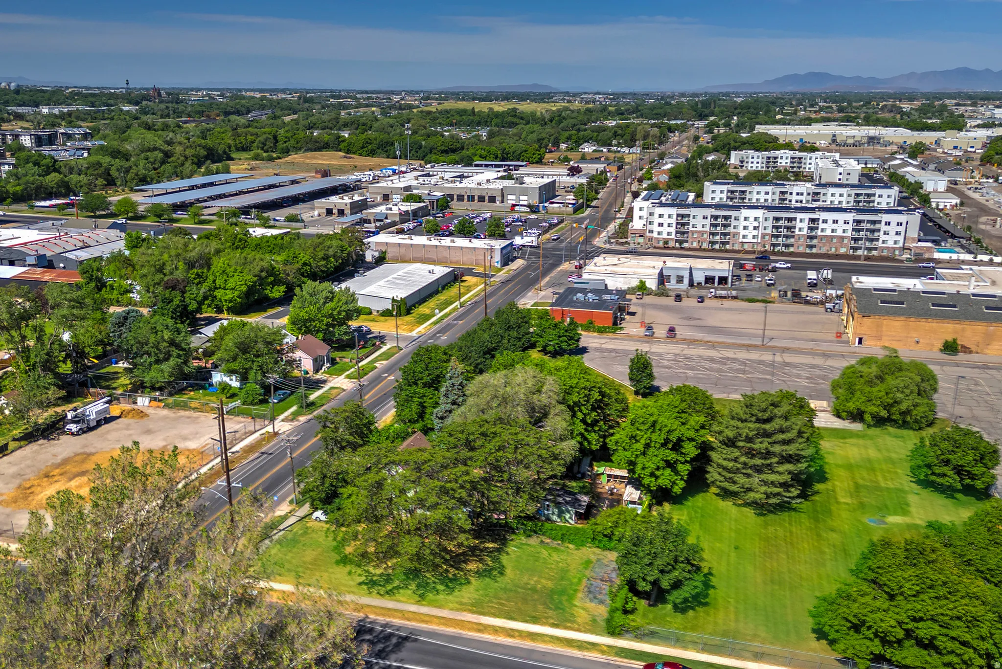 Aerial perspective showcasing a mixed-use neighborhood with residential and commercial properties