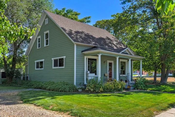 Traditional-style residence featuring a prominent covered front porch with white columns